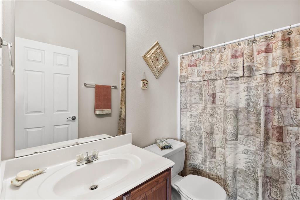 3505 Austin Street Gainesville, TX 76240 - Photo 16 of 20 a bathroom with a sink toilet and shower