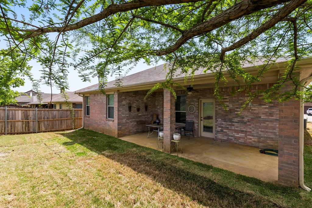 3505 Austin Street Gainesville, TX 76240 - Photo 19 of 20 a view of a house with a patio and a yard