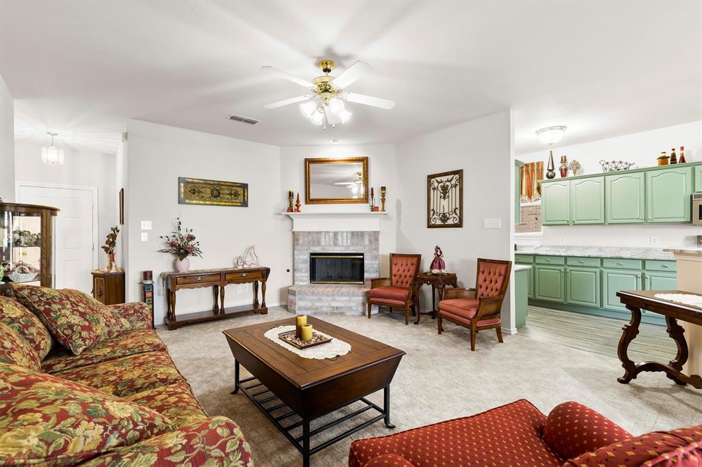 3505 Austin Street Gainesville, TX 76240 - Photo 6 of 20 a living room with furniture a rug and a fireplace
