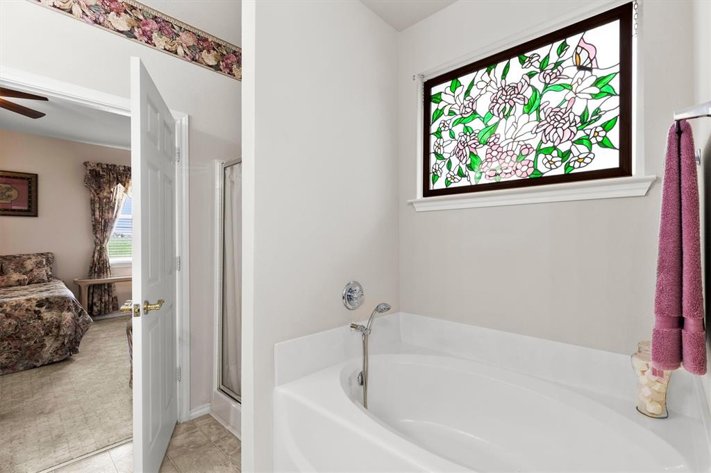 3505 Austin Street Gainesville, TX 76240 - Photo 10 of 20 a white bath tub sitting next to a window