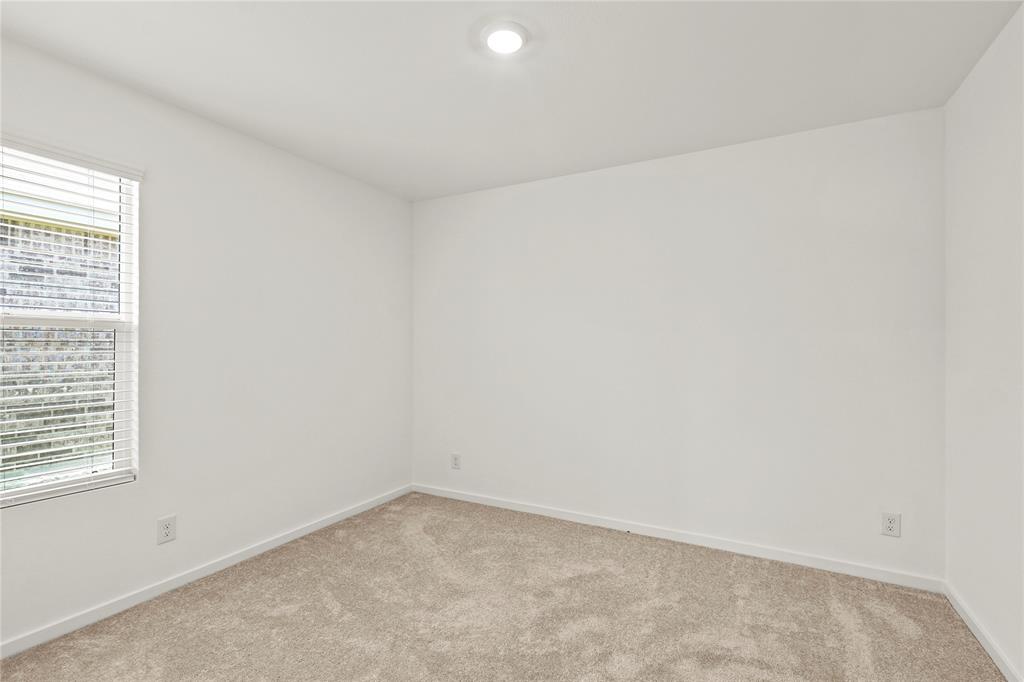 1138 Barbary Flds Street Forney, TX 75126 - Photo 21 of 25 Neutral tone carpeted room with white walls and a single window featuring horizontal blinds