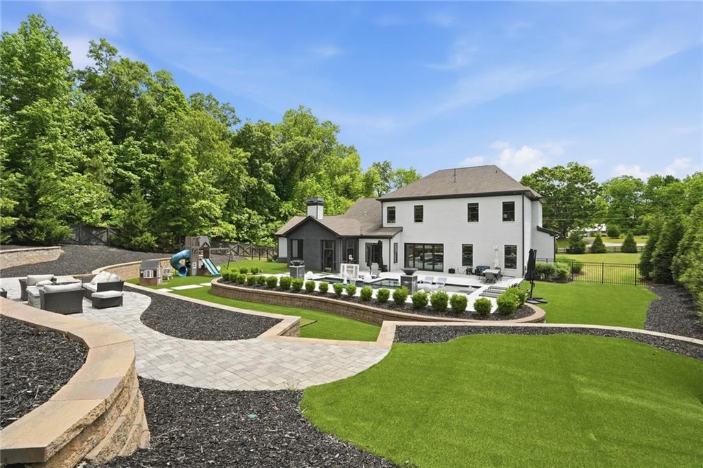 3020 Wallace Road Buford, GA 30519 - Photo 60 of 66 a view of a house with swimming pool and yard