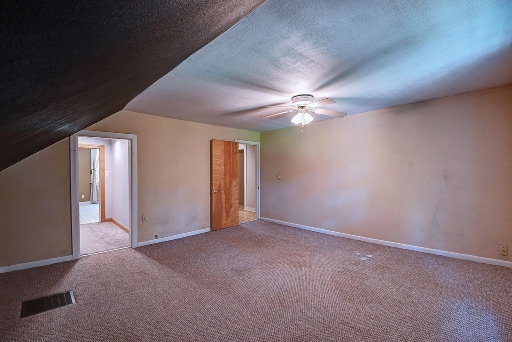 176 Corbin Road Dudley, MA 01571 - Photo 21 of 41 a view of an empty room with a chandelier fan