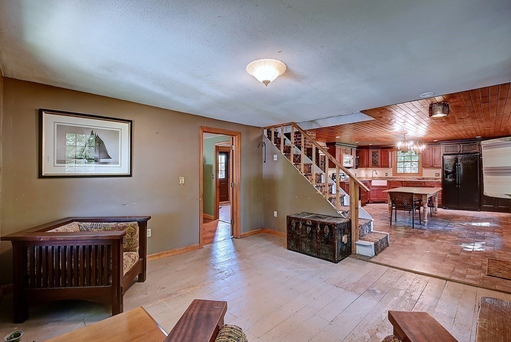 176 Corbin Road Dudley, MA 01571 - Photo 7 of 41 a living room with furniture and stairs