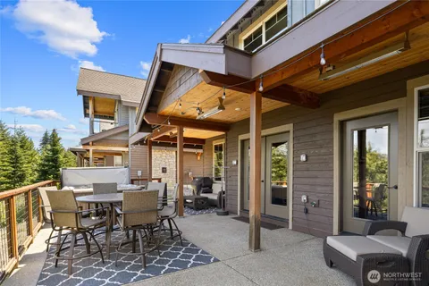 a view of a patio with a table and chairs and potted plants