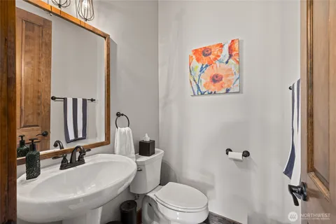 a bathroom with a toilet a sink and mirror