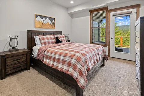 a bedroom with a bed and large window