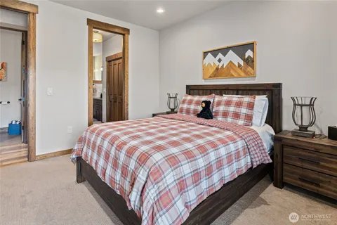 a bedroom with a bed and painting on the wall