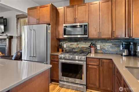 a kitchen with stainless steel appliances granite countertop a refrigerator stove and microwave