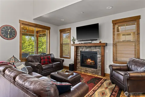 a living room with furniture flat screen tv and a fireplace