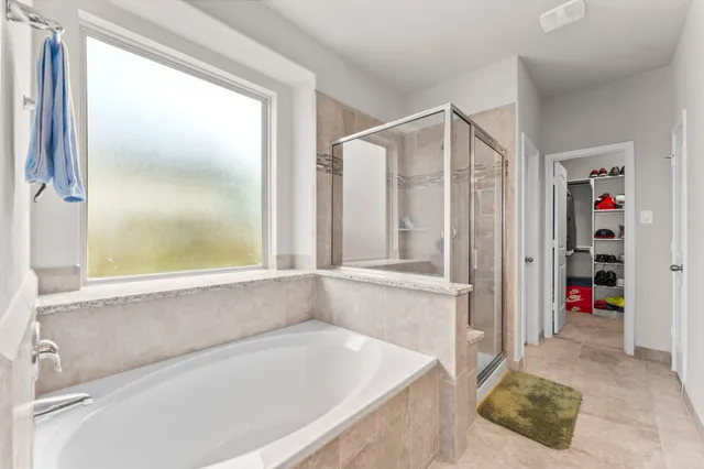 a bathroom with a bathtub and a shower