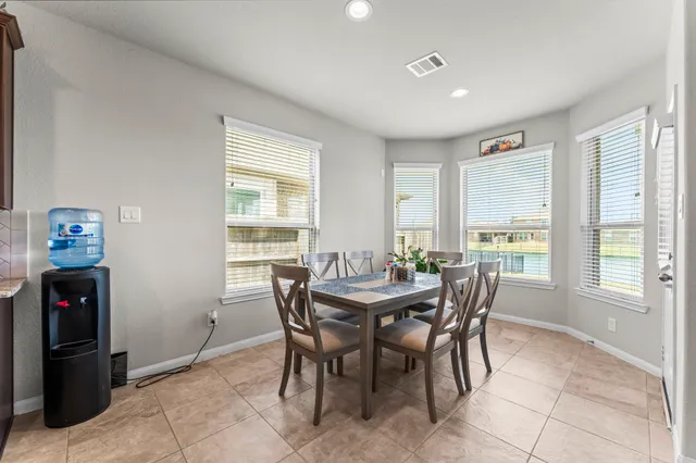 a view of a dining room with furniture and a window