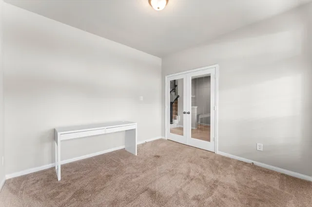 an empty room with windows and entrance