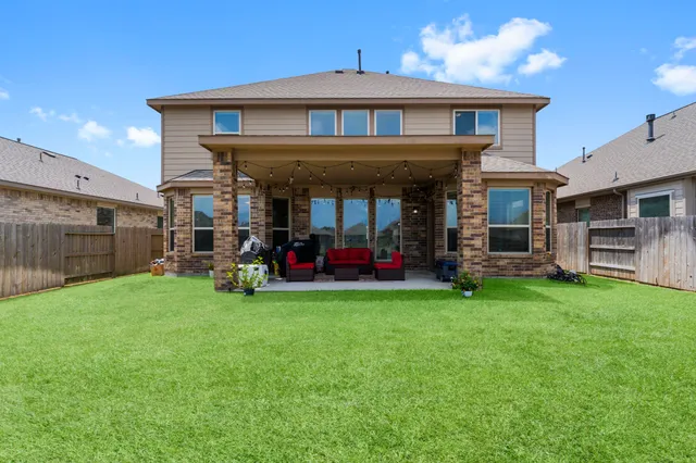 a view of a house with a yard and sitting area