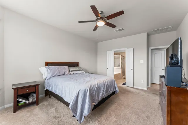 a bedroom with a bed and a chandelier