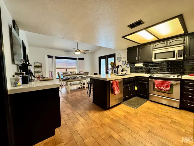 a kitchen with a stove sink and a microwave