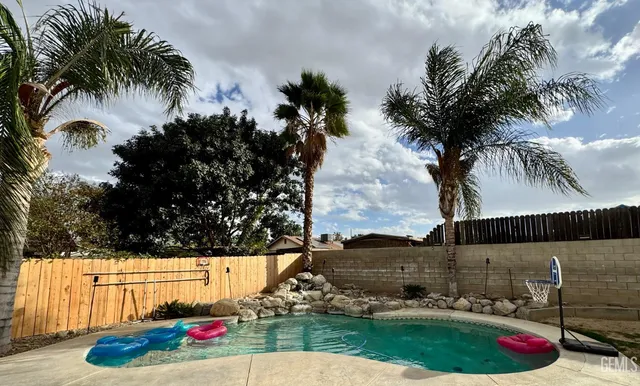 a view of swimming pool from a yard