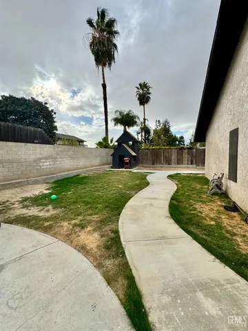 a white house with a yard and sitting area