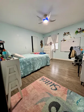 a bedroom with furniture and a wooden floor