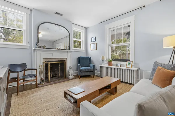 a living room with furniture and a fireplace