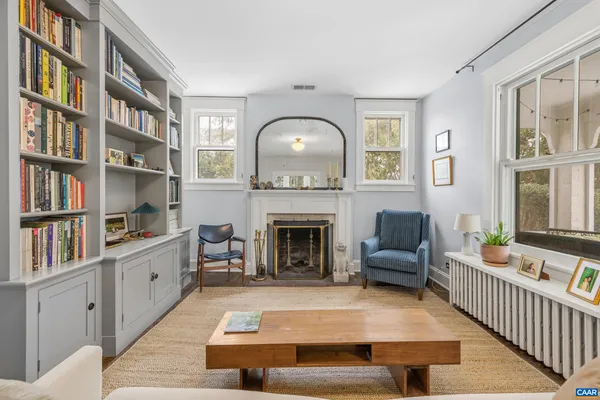 a living room with furniture and wooden floor