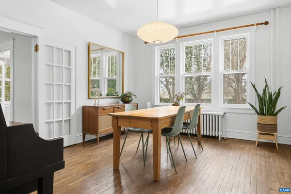 a kitchen with a table chairs stove and cabinets