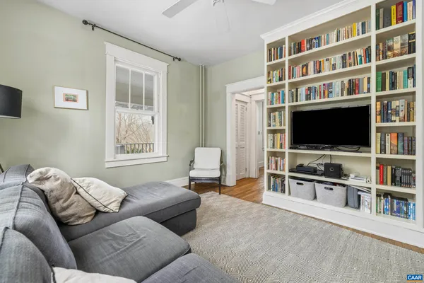a view of a workspace with furniture and a flat screen tv