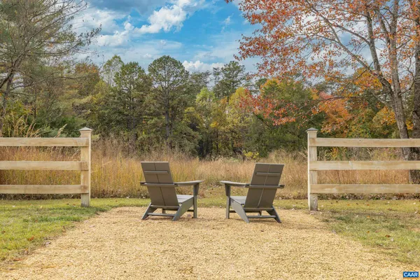 a white bench sitting in a backyard of a house