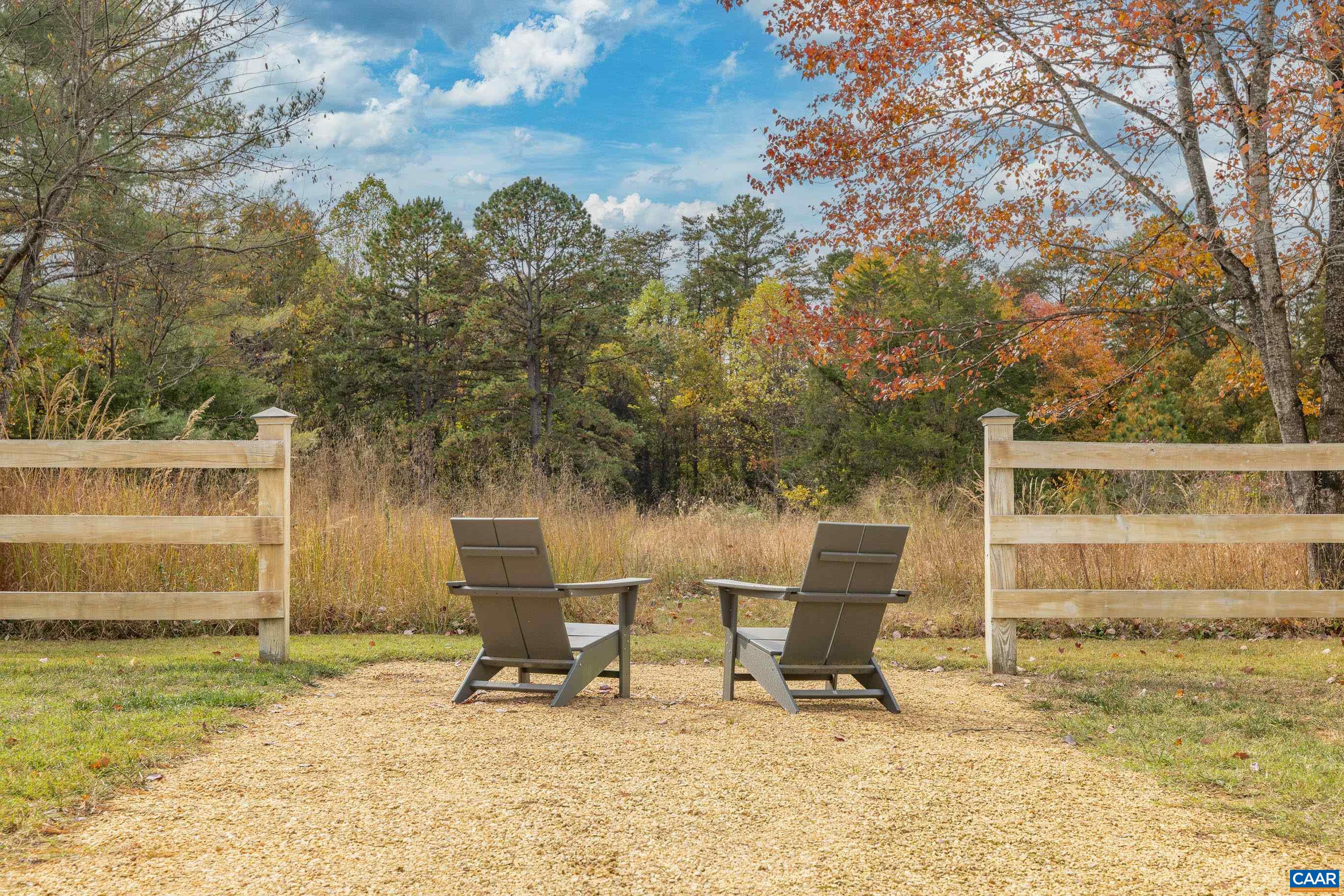 3 Buck Mountain Road Earlysville, VA 22936 - Photo 2 of 48 a white bench sitting in a backyard of a house