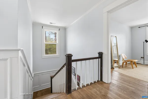 a spacious bedroom with a bed and a window