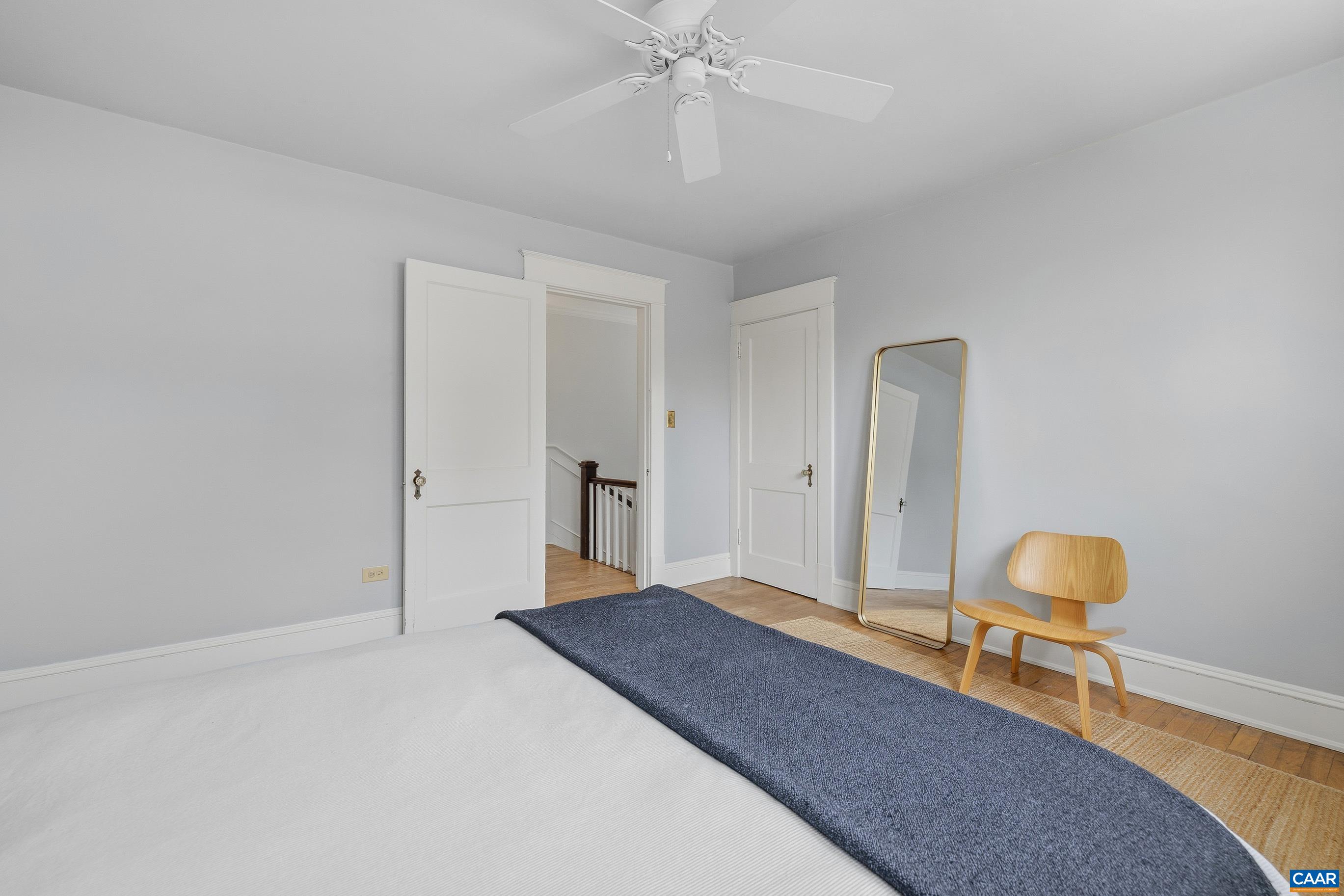 3 Buck Mountain Road Earlysville, VA 22936 - Photo 25 of 48 a bedroom with a bed and a chandelier