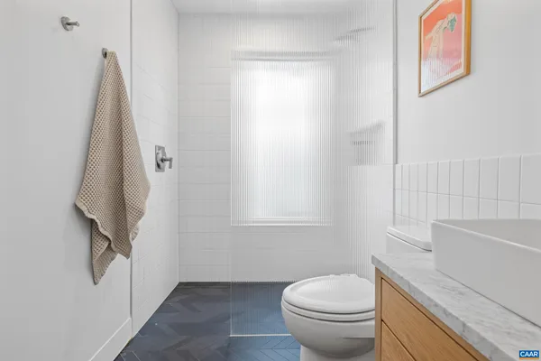 a bedroom with a bed chair and window