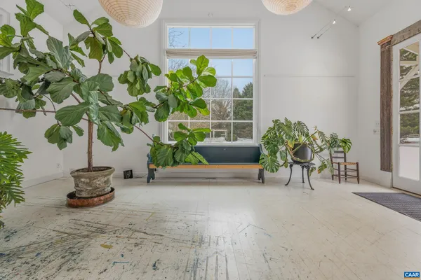 a room with a dining table and a refrigerator