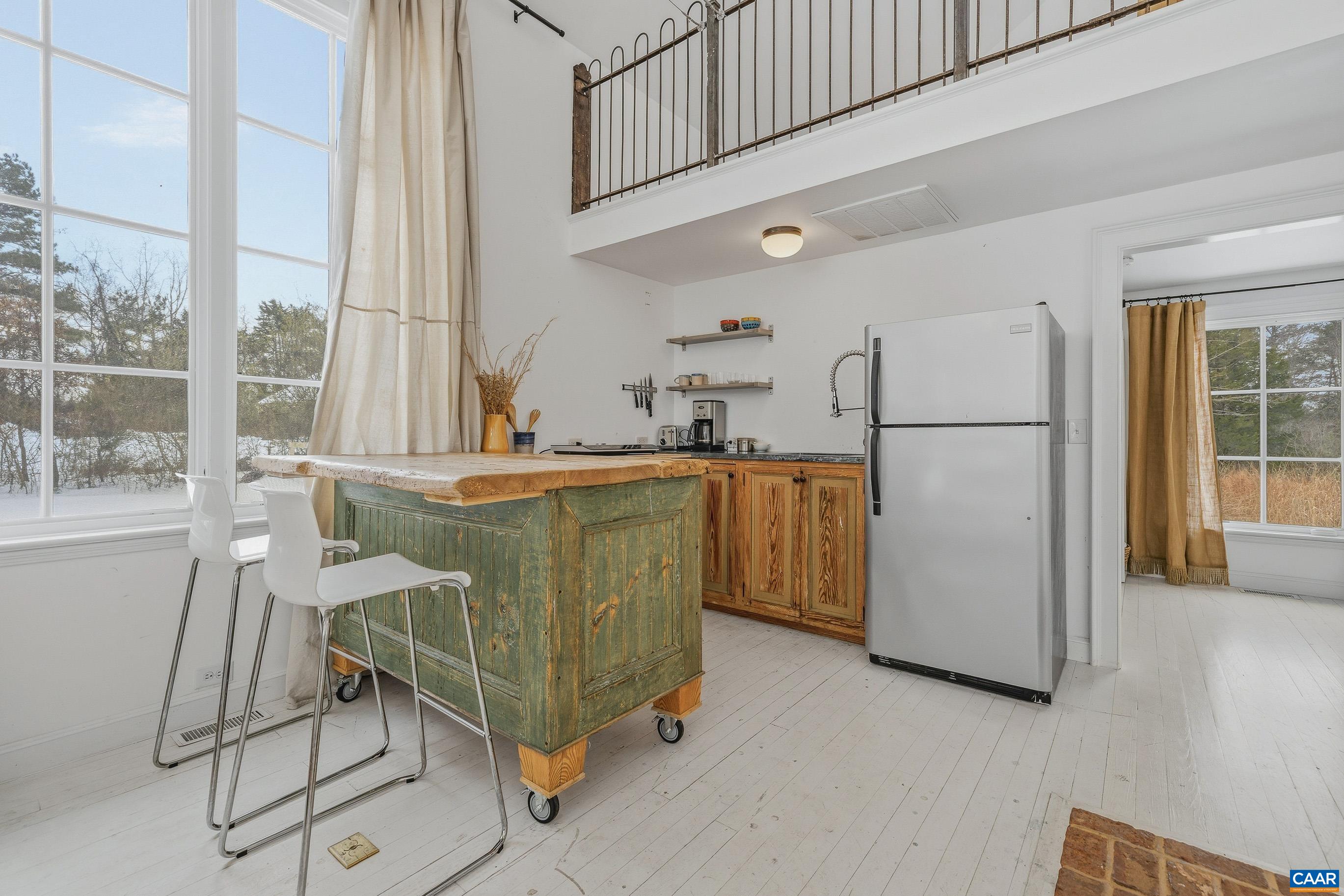 3 Buck Mountain Road Earlysville, VA 22936 - Photo 36 of 48 a room with a dining table and a refrigerator