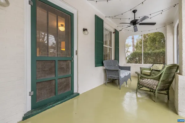 a backyard of a house with plants and large trees