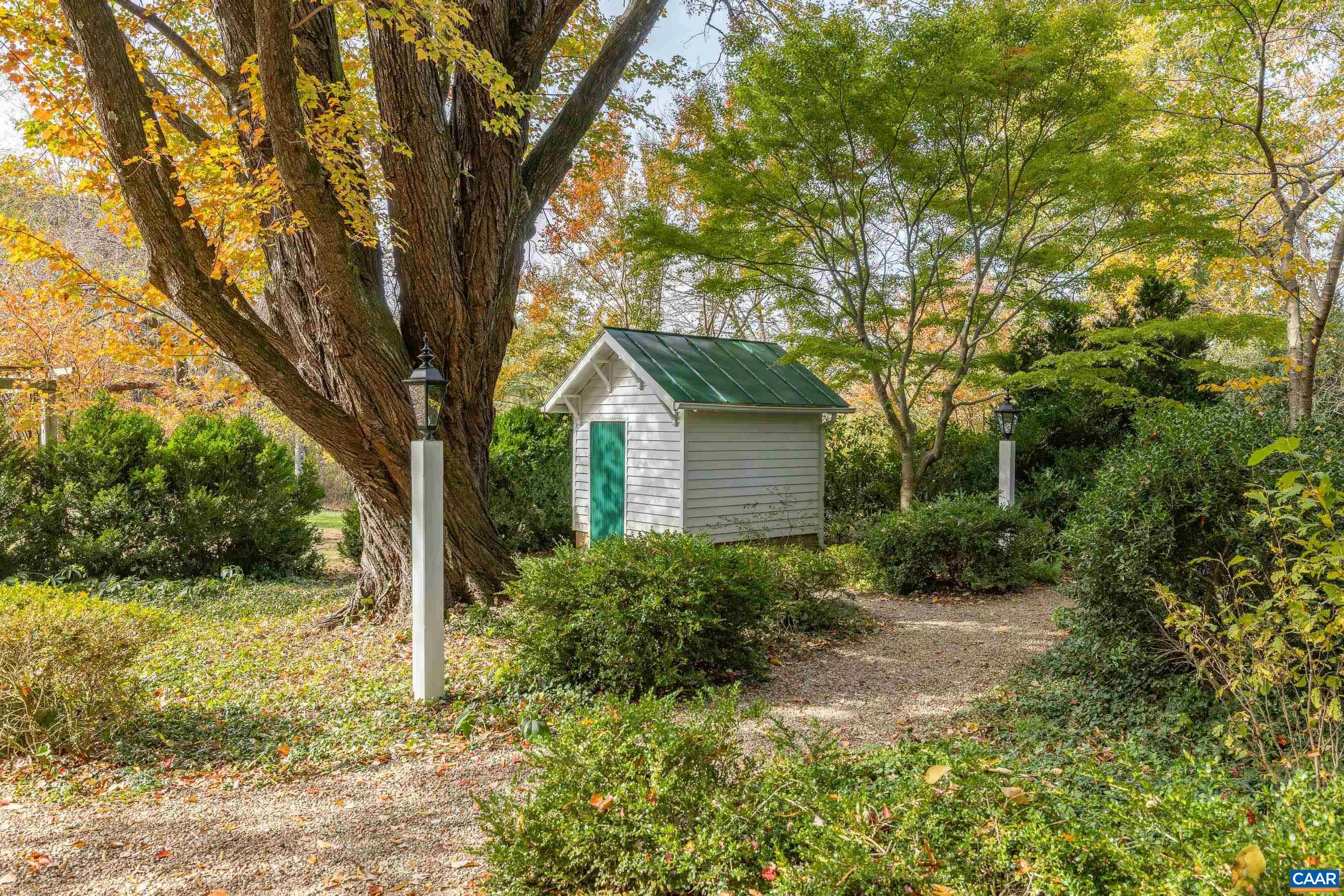 3 Buck Mountain Road Earlysville, VA 22936 - Photo 41 of 48 a backyard of a house with plants and large trees