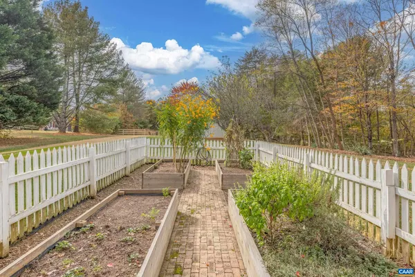 a view of house with backyard and trees