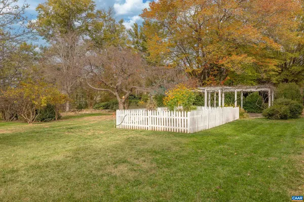a view of backyard of house with green space