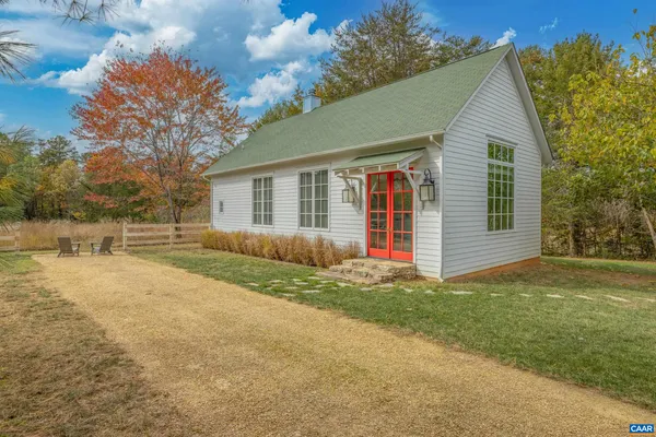 a bedroom with a bed and windows
