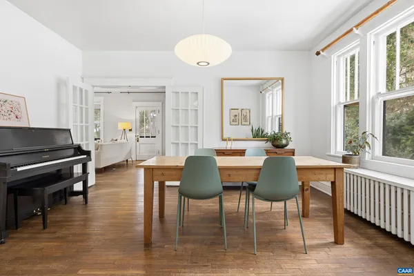 a view of living room with furniture and wooden floor
