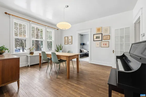 a hallway with wooden floor windows and entryway