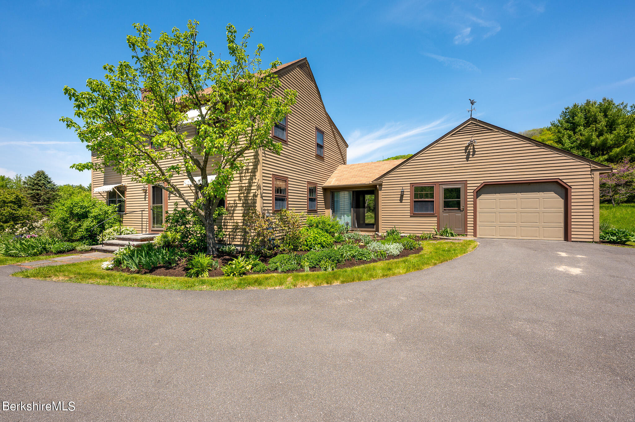 365 State Road Great Barrington, MA 01230 - Photo 6 of 34 a front view of a house with a yard and garage
