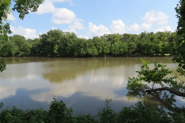 an aerial view of a house with a yard and lake view