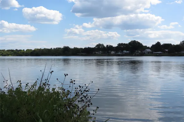 a view of a lake with houses in the back