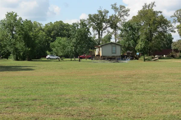 a view of a house with a yard and sitting area