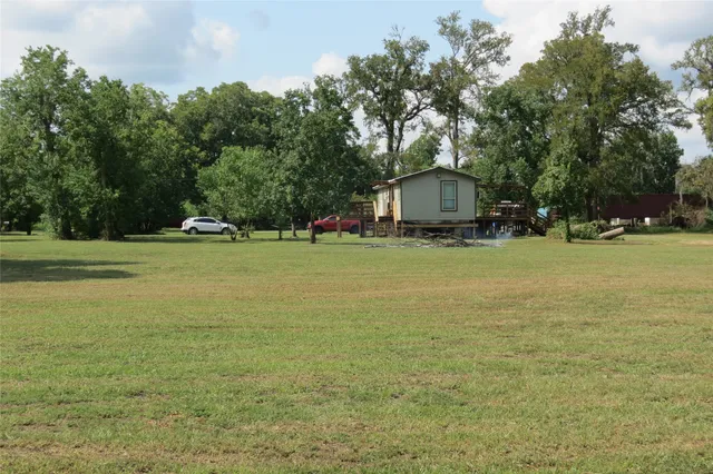 a view of a house with a yard and sitting area