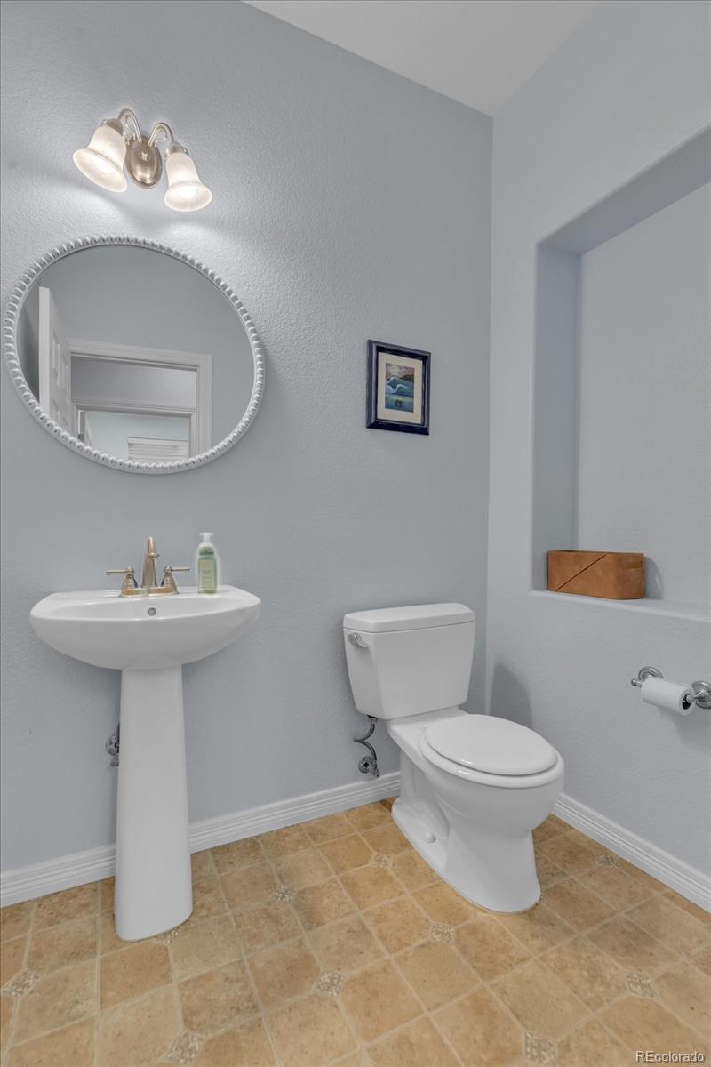 4786 Rabbit Mountain Road Broomfield, CO 80020 - Photo 14 of 41 a bathroom with a sink toilet and a mirror