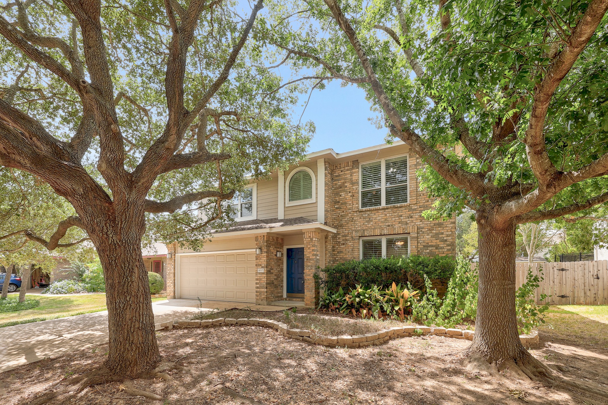 4615 Tello Path Austin, TX 78749 - Photo 2 of 31 Mature trees frame the classic brick facade of this two-story home with an attached garage.