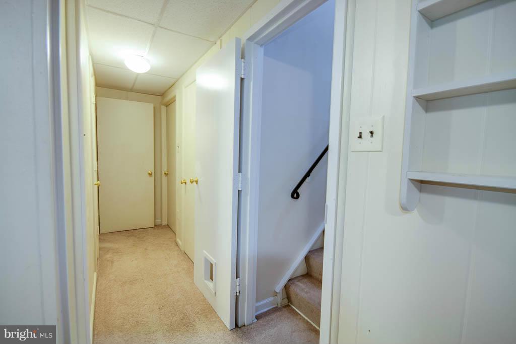 121 Plum Point Road Huntingtown, MD 20639 - Photo 18 of 30 a view of a hallway with closet and a bathroom