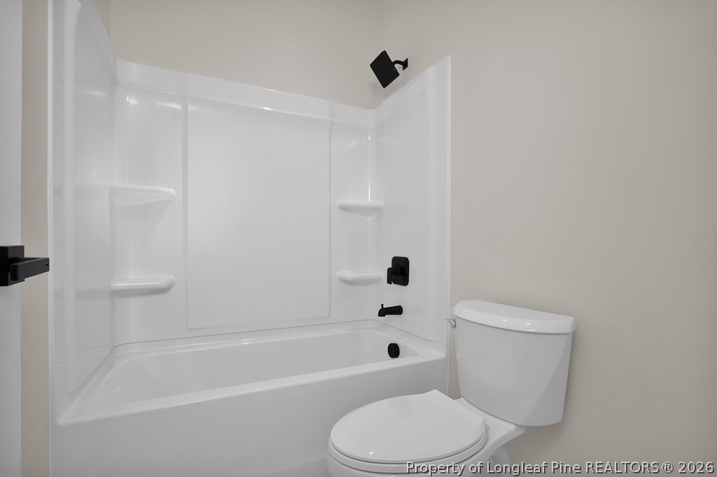 3025 Old Stage Road South Erwin, NC 28339 - Photo 31 of 50 a white toilet and tub sitting next to a bathroom sink